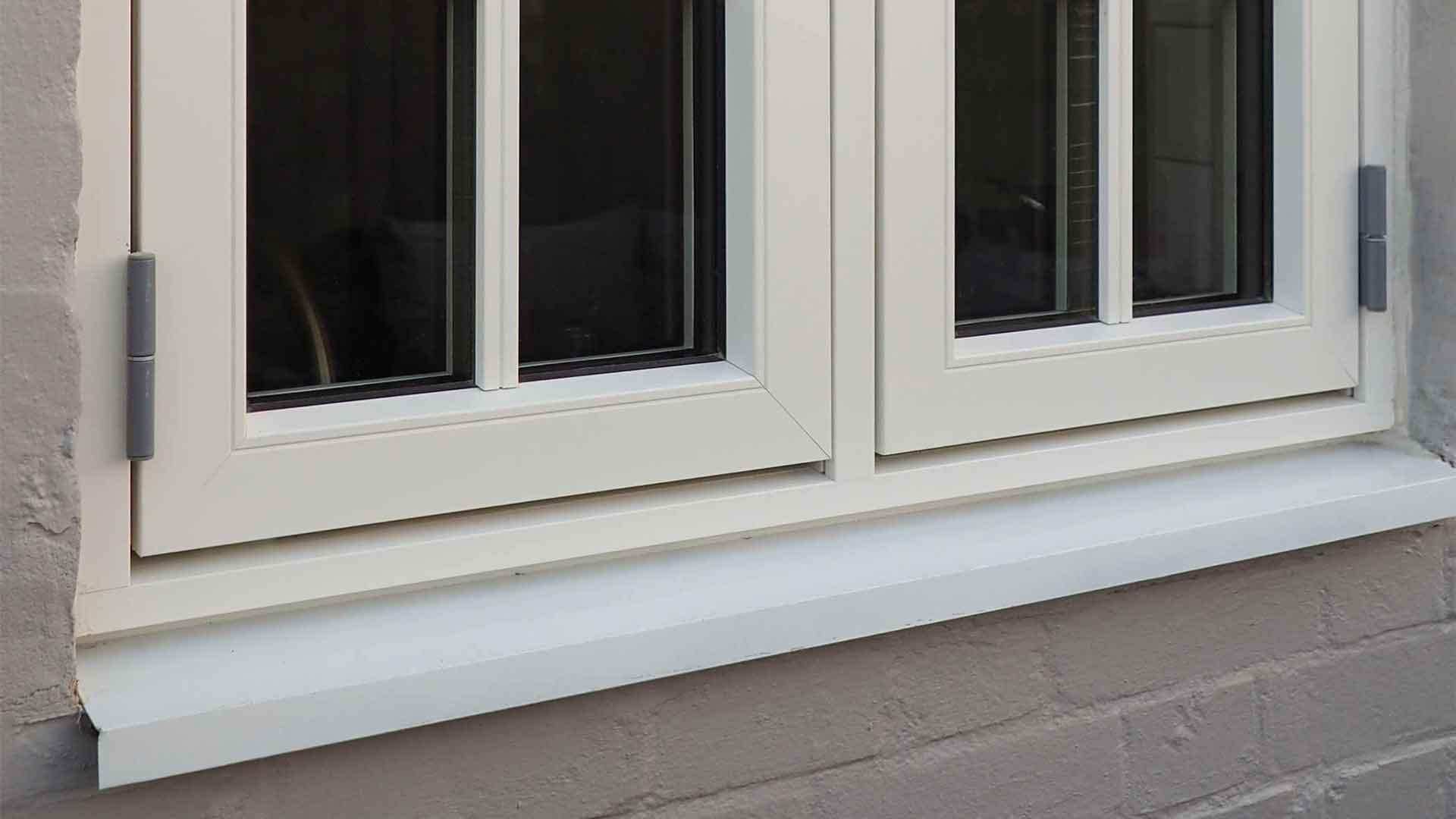 A cottage window with an aluminium cill